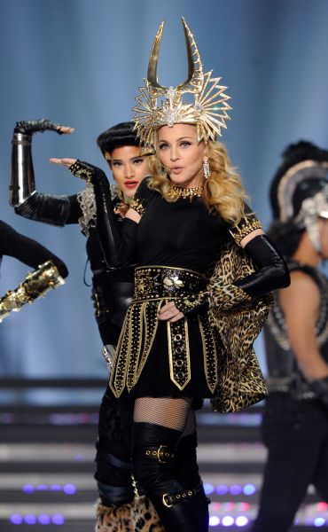 Madonna wearing a gold gladiator-style outfit