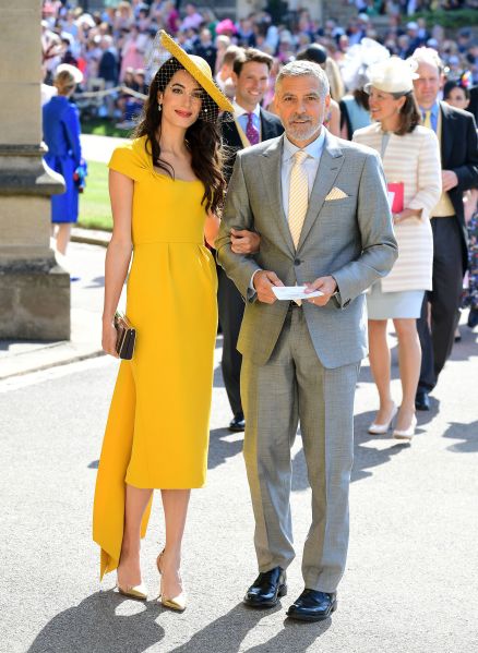 clooney wearing a bright yellow dress with hat